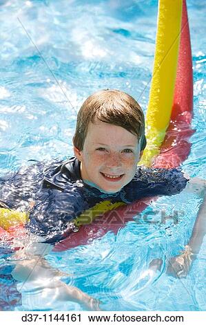 Boy in a swimming pool View Large Photo Image Stock Image - Boy in a swimming pool. Fotosearch
