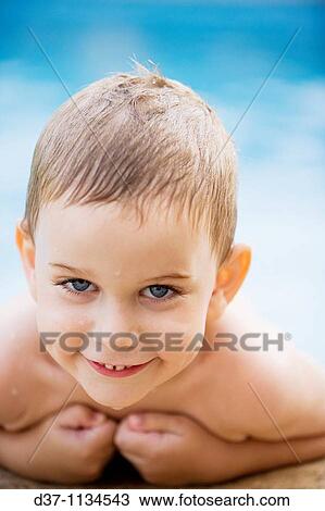 Stock Image - Boy in swimming pool. Fotosearch
