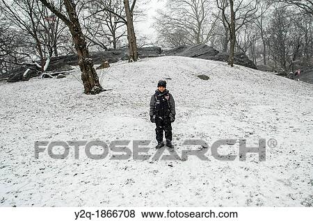 Stock Photo - Boy in the snow in New york. Fotosearch