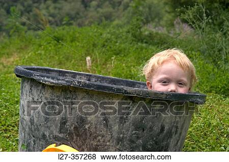 Boy in tub playing outdoors View Large Photo Image Stock Photo - Boy in tub playing outdoors. Fotosearch