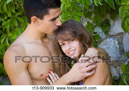 Boy is kissing girl in a head View Large Photo Image Stock Image - Boy is kissing girl in a head. Fotosearch