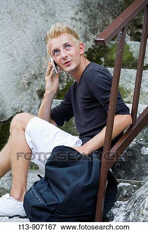 Boy is talking using cellular phone View Large Photo Image Stock Photo - Boy is talking using cellular phone. Fotosearch