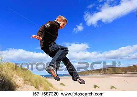 boy jumping from dunes Sutherland, Scotland View Large Photo Image Stock Image - boy jumping from dunes Sutherland, Scotland. Fotosearch