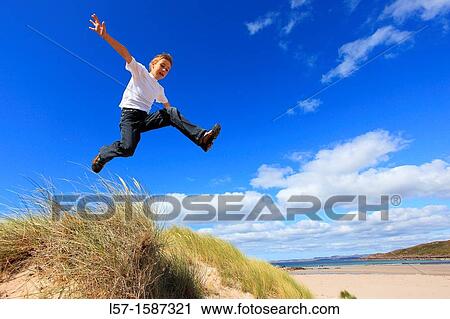 boy jumping from dunes Sutherland, Scotland View Large Photo Image Stock Image - boy jumping from dunes Sutherland, Scotland. Fotosearch