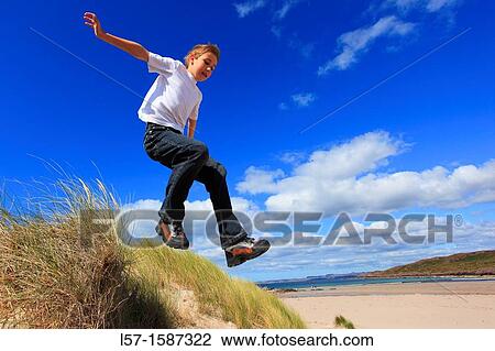 boy jumping from dunes Sutherland, Scotland View Large Photo Image Stock Image - boy jumping from dunes Sutherland, Scotland. Fotosearch