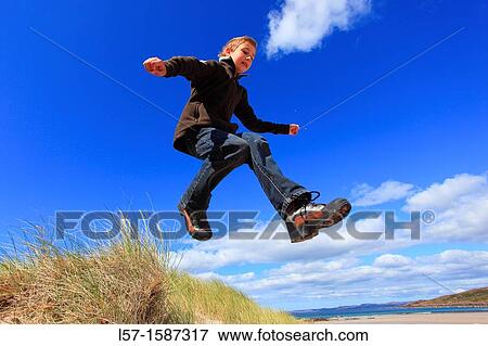 boy jumping from dunes Sutherland, Scotland View Large Photo Image Stock Photo - boy jumping from dunes Sutherland, Scotland. Fotosearch