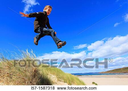 boy jumping from dunes Sutherland, Scotland View Large Photo Image Stock Photo - boy jumping from dunes Sutherland, Scotland. Fotosearch