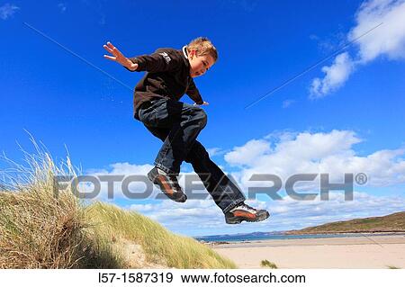 boy jumping from dunes Sutherland, Scotland View Large Photo Image Stock Photo - boy jumping from dunes Sutherland, Scotland. Fotosearch