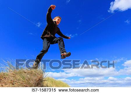 boy jumping from dunes Sutherland, Scotland View Large Photo Image Stock Photography - boy jumping from dunes Sutherland, Scotland. Fotosearch