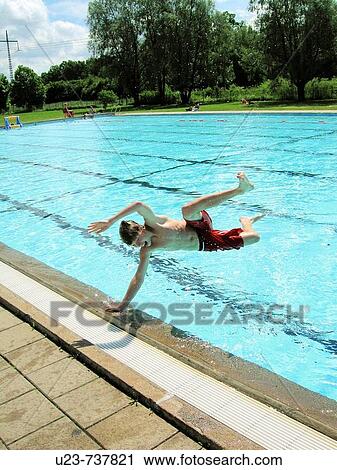Boy jumping into the water. View Large Photo Image Stock Image - Boy jumping into the water.. Fotosearch