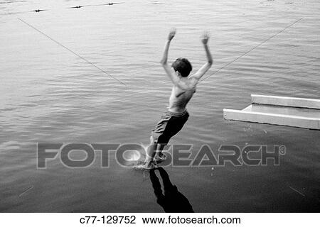 Boy jumping into water View Large Photo Image Stock Image - Boy jumping into water. Fotosearch