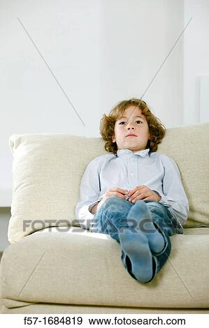 Boy laying on coach View Large Photo Image Stock Photo - Boy laying on coach. Fotosearch