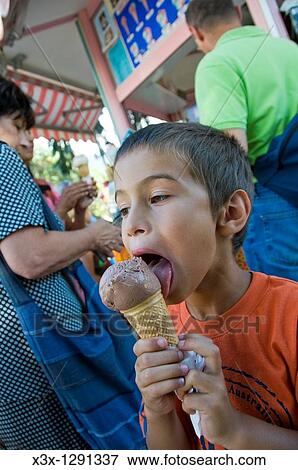 Boy licking ice cream cone View Large Photo Image Stock Photo - Boy licking ice cream cone. Fotosearch