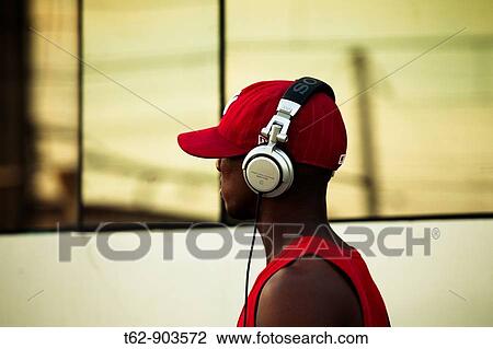 Boy listening to music on their headphones View Large Photo Image Stock Image - Boy listening to music on their headphones. Fotosearch