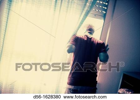 Boy looking through a window, Benidorm, Alicante province, Spain View Large Photo Image Stock Image - Boy looking through a window, Benidorm, Alicante province, Spain. Fotosearch