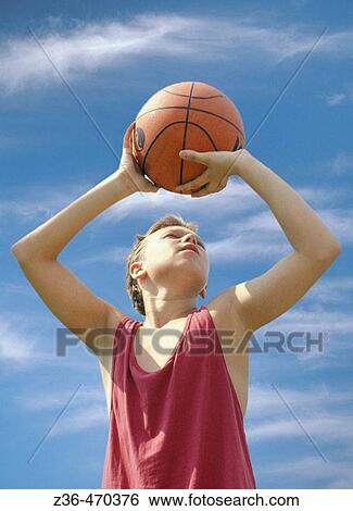 Stock Photograph - Boy making a shot. Fotosearch