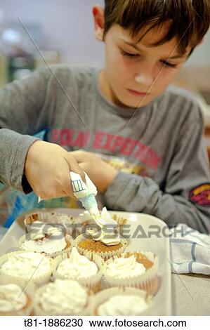 Boy making cupcakes View Large Photo Image Stock Image - Boy making cupcakes. Fotosearch