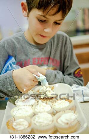 Boy making cupcakes View Large Photo Image Stock Image - Boy making cupcakes. Fotosearch