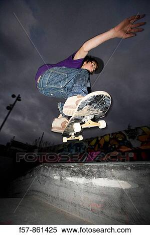 Boy ollie's at a skatepark View Large Photo Image Stock Photography - Boy ollie's at a skatepark. Fotosearch