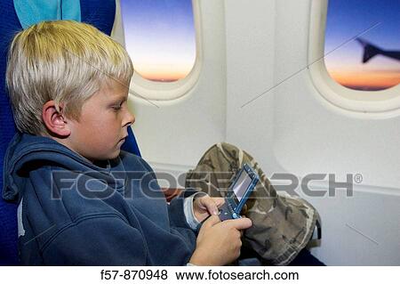 Stock Photo - Boy on a 747 aircraft, Malaysia. Fotosearch