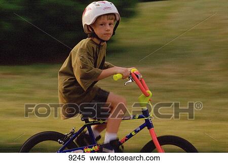 Boy on bike View Large Photo Image Stock Photography - Boy on bike. Fotosearch