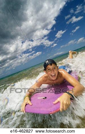Boy on boogie board View Large Photo Image Stock Photo - Boy on boogie board. Fotosearch