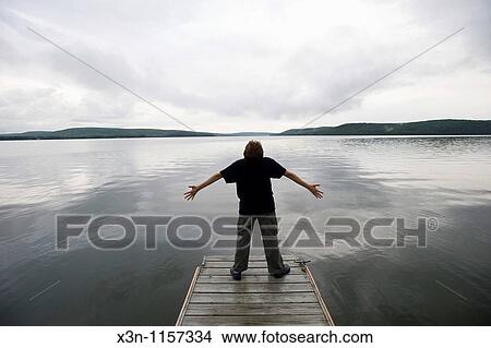 Boy on dock View Large Photo Image Picture - Boy on dock. Fotosearch