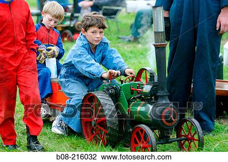 Boy on mini steam engine at steam rally. Derbyshire. England View Large Photo Image Stock Image - Boy on mini steam engine at steam rally. Derbyshire. England. Fotosearch