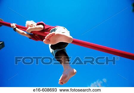 Boy on playground bars View Large Photo Image Stock Image - Boy on playground bars. Fotosearch