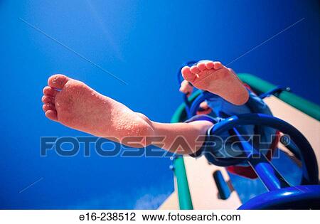 Stock Image - boy on playground equipment. Fotosearch