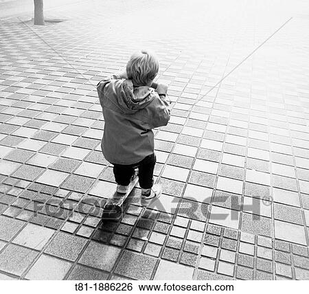 Boy on scooter View Large Photo Image Stock Photograph - Boy on scooter. Fotosearch