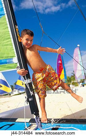 Boy on sunfish sailboat, Bahamas View Large Photo Image Picture - Boy on sunfish sailboat, Bahamas. Fotosearch