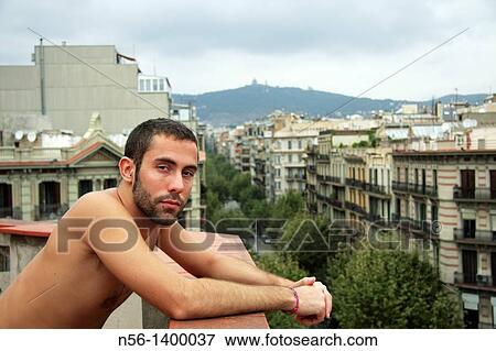 Stock Photo - Boy on terrace roof, Barcelona, Catalonia, Spain. Fotosearch
