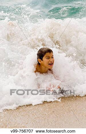 Boy on the beach View Large Photo Image Stock Photo - Boy on the beach. Fotosearch