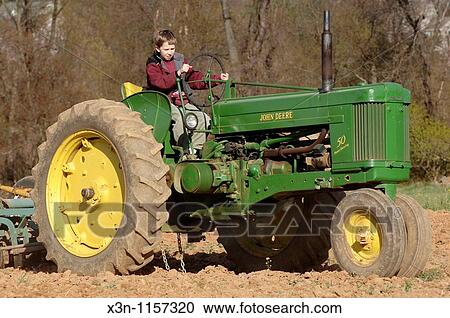 Boy on tractor View Large Photo Image Stock Image - Boy on tractor. Fotosearch