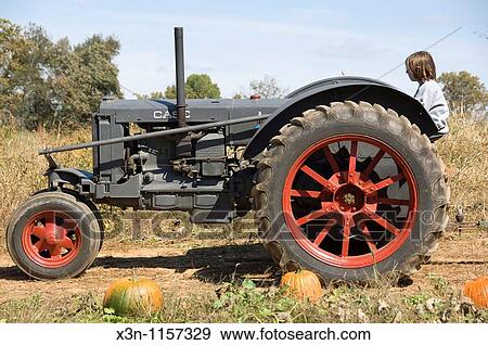 Boy on tractor View Large Photo Image Stock Photo - Boy on tractor. Fotosearch