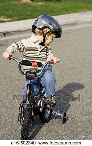 Boy on tricycle View Large Photo Image Stock Image - Boy on tricycle. Fotosearch