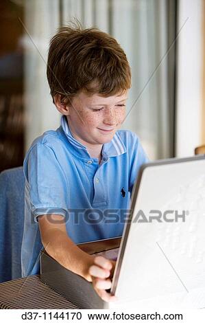 Boy opening a small case View Large Photo Image Stock Image - Boy opening a small case. Fotosearch