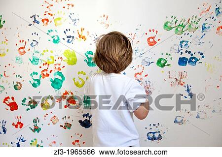 Boy painting a white wall with his hands View Large Photo Image Stock Photograph - Boy painting a white wall with his hands. Fotosearch