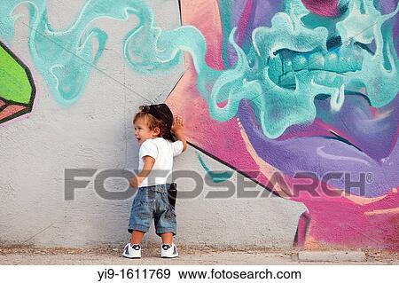 boy painting graffiti on the wall View Large Photo Image Stock Photo - boy painting graffiti on the wall. Fotosearch