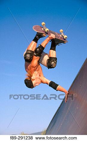Boy performing hand plant on skateboard half pipe. Mount Vernon. Washington, USA View Large Photo Image Stock Photo - Boy performing hand plant on skateboard half pipe. Mount Vernon. Washington, USA. Fotosearch
