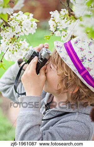 Boy photographing in the garden. View Large Photo Image Stock Photo - Boy photographing in the garden.. Fotosearch