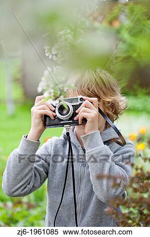 Boy photographing in the garden. View Large Photo Image Stock Photography - Boy photographing in the garden.. Fotosearch