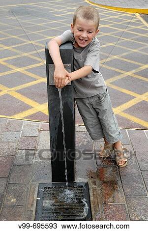 Boy playing at fountain View Large Photo Image Stock Image - Boy playing at fountain. Fotosearch