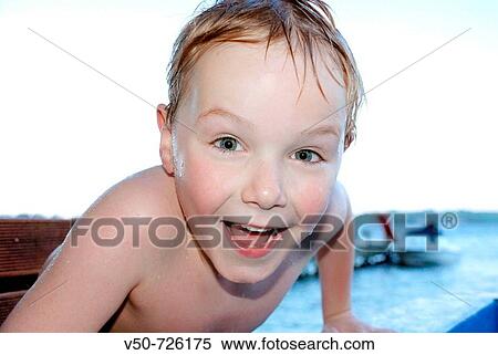 Stock Photography - Boy playing at natural hot pools called Rotoiti, on the Rotorua area, New Zealand. Fotosearch