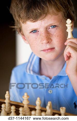 Boy playing chess View Large Photo Image Stock Photo - Boy playing chess. Fotosearch