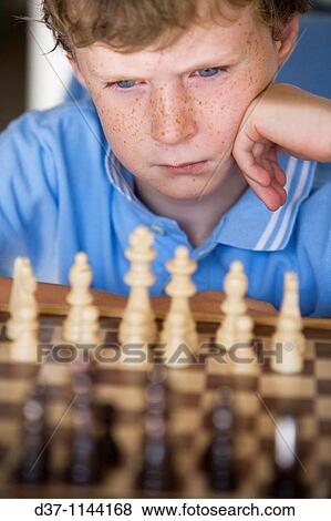 Boy playing chess View Large Photo Image Stock Photo - Boy playing chess. Fotosearch