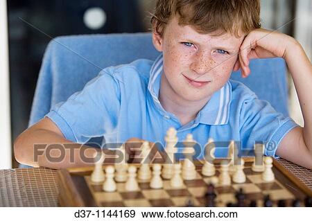 Boy playing chess View Large Photo Image Stock Photo - Boy playing chess. Fotosearch