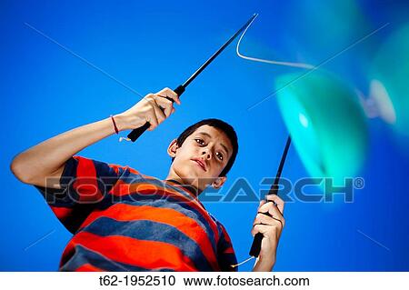 Boy playing diabolo. Color. View Large Photo Image Stock Image - Boy playing diabolo. Color.. Fotosearch