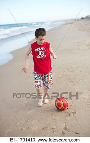 Boy playing football at the beach, El Saler beach, Albufera de Valencia Nature Reserve, Spain, Valencia View Large Photo Image Stock Image - Boy playing football at the beach, El Saler beach, Albufera de Valencia Nature Reserve, Spain, Valencia. Fotosearch